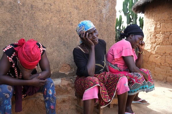 Women mourn the death of a family member following an attack by gunmen in the Zike farming community in north-central Nigeria, Tuesday, April 15, 2025. (AP Photo/Samson Omale)