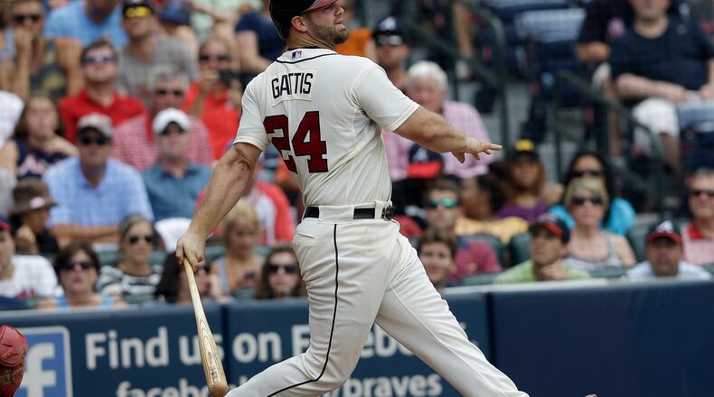 Atlanta Braves Evan Gattis bats against the Cincinnati Reds in a baseball game Sunday, July 14, 2013 in Atlanta.