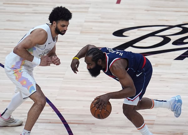 Los Angeles Clippers guard James Harden, right, collects a loose ball as Denver Nuggets guard Jamal Murray defends in the first half of Game 5 of an NBA basketball playoff series Tuesday, April 29, 2025, in Denver. (AP Photo/David Zalubowski)