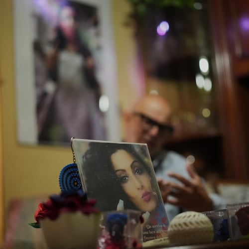Angelo Venturato talks during an interview with the Associated Press next to photos of his daughter Maria who died at the age of 25 of a cancer he claims to be connected to decades of pollution from illegal waste dumping and burning, much of it linked to organized criminal groups, in the southern town of Acerra, Friday, May 22, 2026. (AP Photo/Andrew Medichini)