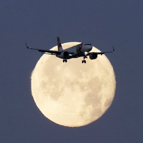 FILE - A TAP Air Portugal Airbus A320 is silhouetted against the setting moon while approaching for landing in Lisbon, Portugal, June 23, 2024. (AP Photo/Armando Franca, File)