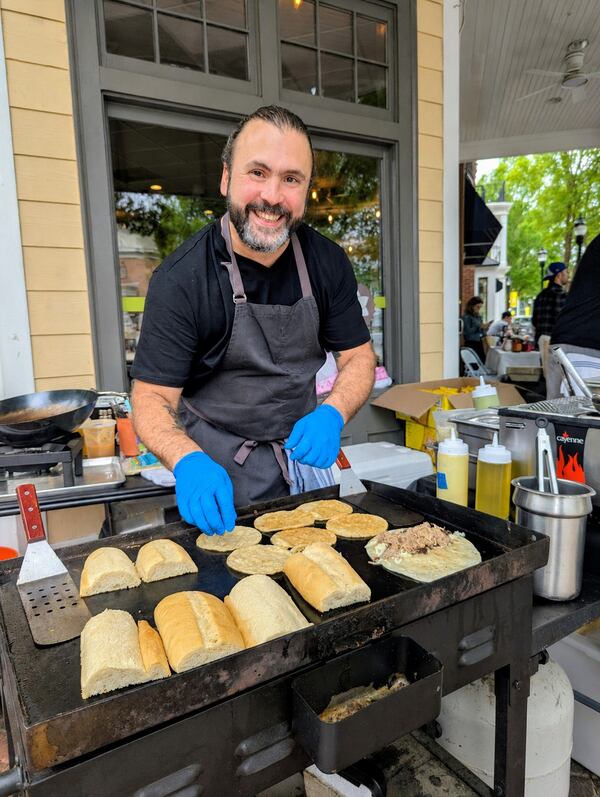 Chef Danny Bustamante cooking at an outdoor pop-up.
