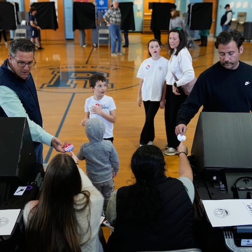 Voters receive stickers after voting at a polling site in River Edge, N.J., Tuesday, Nov. 4, 2025. (AP Photo/Seth Wenig)