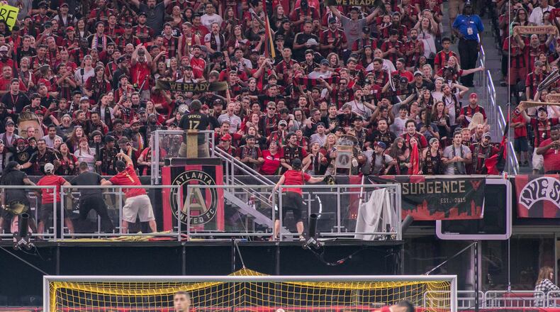 Atlanta United fans cheer in the stands as players warm up before a Major League Soccer game between the Atlanta United and Montreal Impact at the Mercedes-Benz Stadium , Sunday, Sept. 24, 2017, in Atlanta.  BRANDEN CAMP/SPECIAL