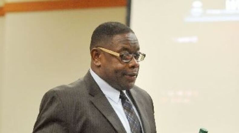 Former DeKalb County purchasing director Kelvin Walton leaves the courtroom following his recall to discuss secret recordings Friday. KENT D. JOHNSON /KDJOHNSON@AJC.COM