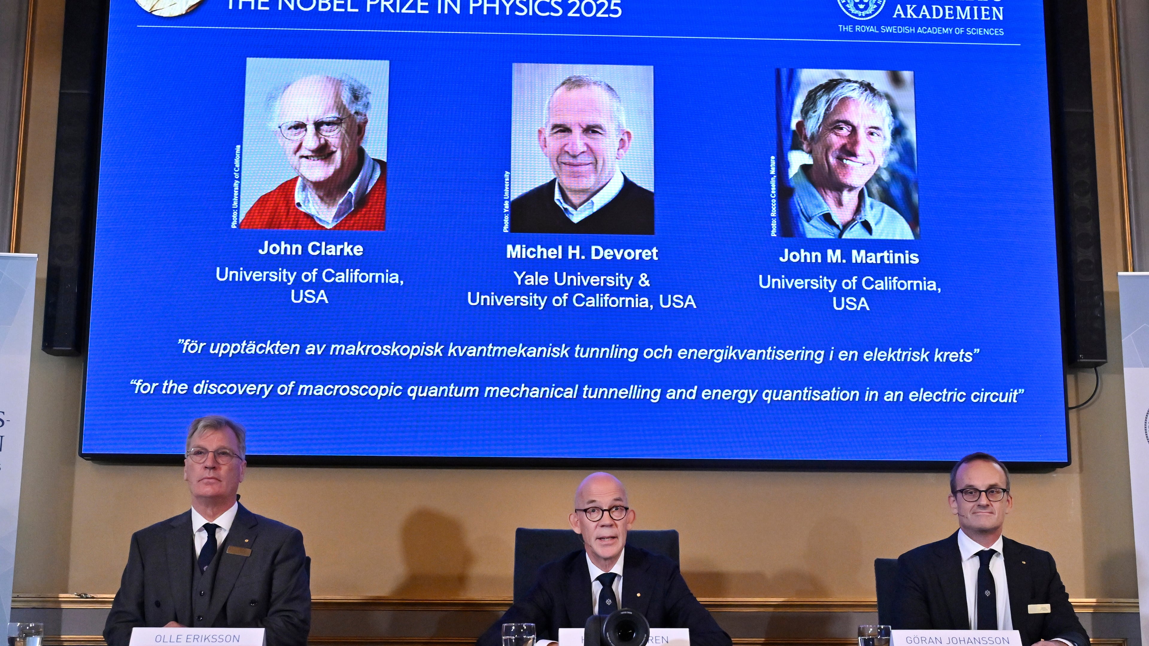 From left, Chair of the Nobel Committee for Physics Chair Olle Eriksson, Secretary General of the Swedish Academy of Sciences Hans Ellegren and Member of the Nobel Committee for Physics Goran Johansson announce John Clarke, Michel H Devoret and John M. Martinis, on screen behind, as the recipients the Nobel Prize in Physics, at the Nobel Assembly of the Karolinska Institutet, in Stockholm, Sweden, Tuesday, Oct. 7, 2025. (Christine Olsson/TT News Agency via AP)