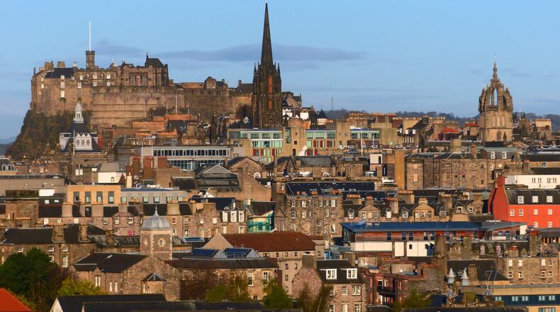 The higgledy-piggledy roofscape of Old Town Edinburgh is seen from the Radical Road trail at the foot of Salisbury Crags. Narrow, hidden "closes," or pedestrian alleyways, bisect many of the old buildings. (Brian J. Cantwell/The Seattle Times/TNS)