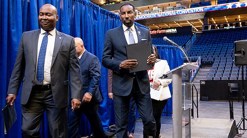 220728-Atlanta-Democratic National Committee Chair Jaime Harrison, left, and Atlanta Mayor Andre Dickens leave the stage after speaking to journalists after touring State Farm Arena on Thursday, July28, 2022, as part of Atlanta’s bid to host the 2024 Democratic National Convention.  Ben Gray for the Atlanta Journal-Constitution