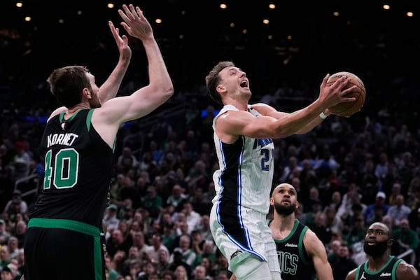 Orlando Magic forward Franz Wagner, right, drives to the basket against Boston Celtics center Luke Kornet (40) during the first half in Game 5 of a first-round NBA playoff basketball series, Tuesday, April 29, 2025, in Boston. (AP Photo/Charles Krupa)