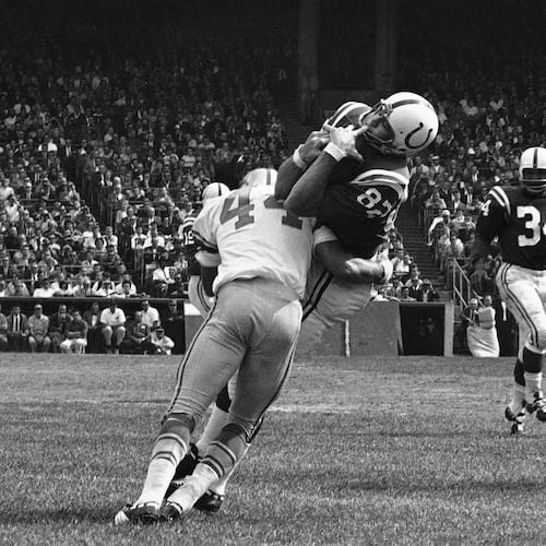 FILE - In this Sept. 30, 1962, file photo, Baltimore Colts end Raymond Berry snags a pass from quarterback John Unitas for 5-yard gain against the Detroit Lions in a football game in Baltimore. Lions' Dick LeBeau (44) makes the tackle. (AP Photo/File)