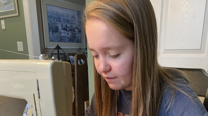 Bryn Hammock works on her "Tiny Hugs" project. These fabric gloves filled with weighted beads are used to comfort newborns in the neonatal intensive care unit when their parents cannot be with them. Courtesy of Bryn Hammock