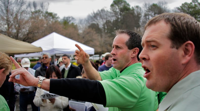 Auctioneers Tom Zeller (right) and Marshall McAbee elicit bids at a 2013 foreclosure auction in Gwinnett County. Photo by Bob Andres, AJC