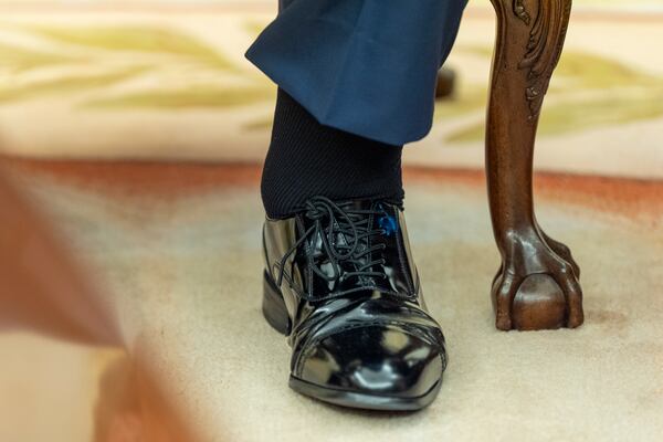 The left foot and swollen of President Donald Trump are pictured as he sits with Bahrain's Crown Prince Salman bin Hamad Al Khalifa in the Oval Office of the White House, Wednesday, July 16, 2025, in Washington. (AP Photo/Alex Brandon)