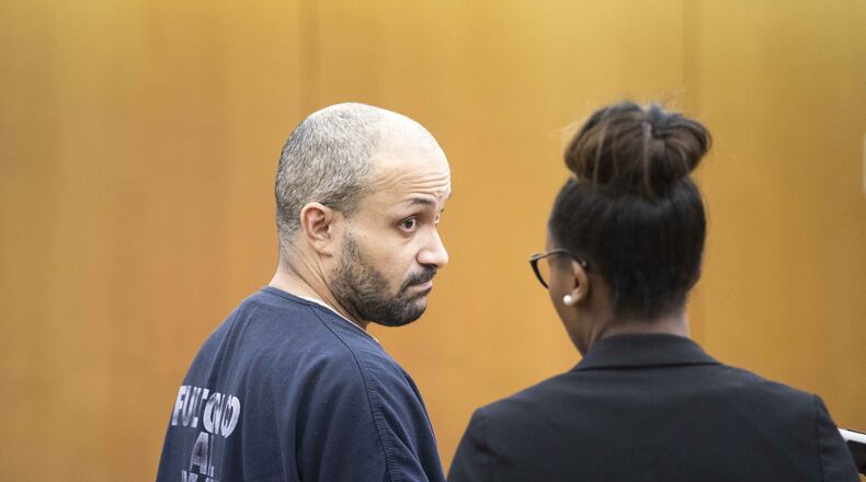 Christopher Clemons listens to his attorney during a plea in the courtroom of Thomas A. Cox, Jr. at Fulton County Superior Court on Tuesday, Jan. 23. ALYSSA POINTER/ALYSSA.POINTER@AJC.COM
