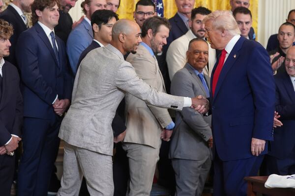 President Donald Trump, right, greets Los Angeles Dodgers' Mookie Betts during a ceremony to honor the Major League Baseball 2024 World Series Champion Los Angeles Dodgers in the East Room of the White House, Monday, April 7, 2025, in Washington. (AP Photo/Evan Vucci)