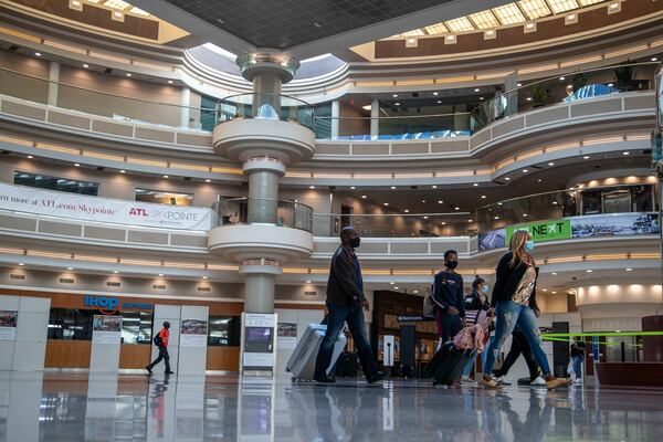 11/23/2020 �  Atlanta, Georgia �People walk through the atrium in the Domestic Terminal at Hartsfield-Jackson Atlanta International Airport in Atlanta , Monday, November 23, 2020.  (Alyssa Pointer / Alyssa.Pointer@ajc.com)