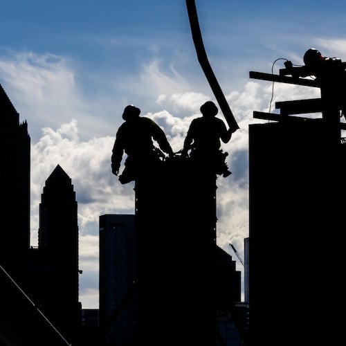 Construction workers pour concrete into forms along Bishop Street near 17th Street in West Midtown Atlanta in 2024 as they work on a mixed-use project called UrbA ATL. Much has changed over the past 30 years in Atlanta, both the city and the region, in terms of size, diversity, and population. (John Spink/AJC 2024)