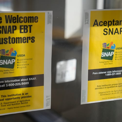 Signage showing that USDA Supplemental Nutrition Assistance Program (SNAP) is accepted, is displayed at Wild Onion Market, Monday, Oct. 27, 2025, in Chicago. (AP Photo/Erin Hooley)
