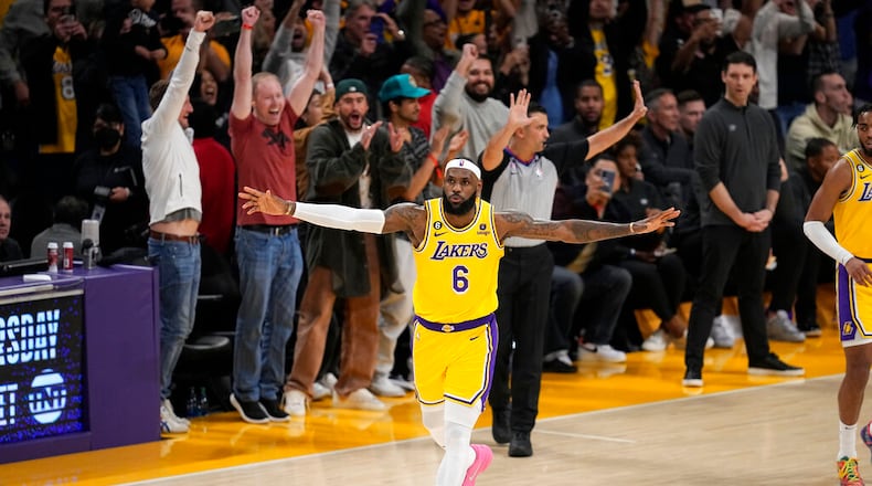 Los Angeles Lakers forward LeBron James celebrates after scoring to pass Kareem Abdul-Jabbar to become the NBA's all-time leading scorer during the second half of an NBA basketball game against the Oklahoma City Thunder Tuesday, Feb. 7, 2023, in Los Angeles. (AP Photo/Mark J. Terrill)