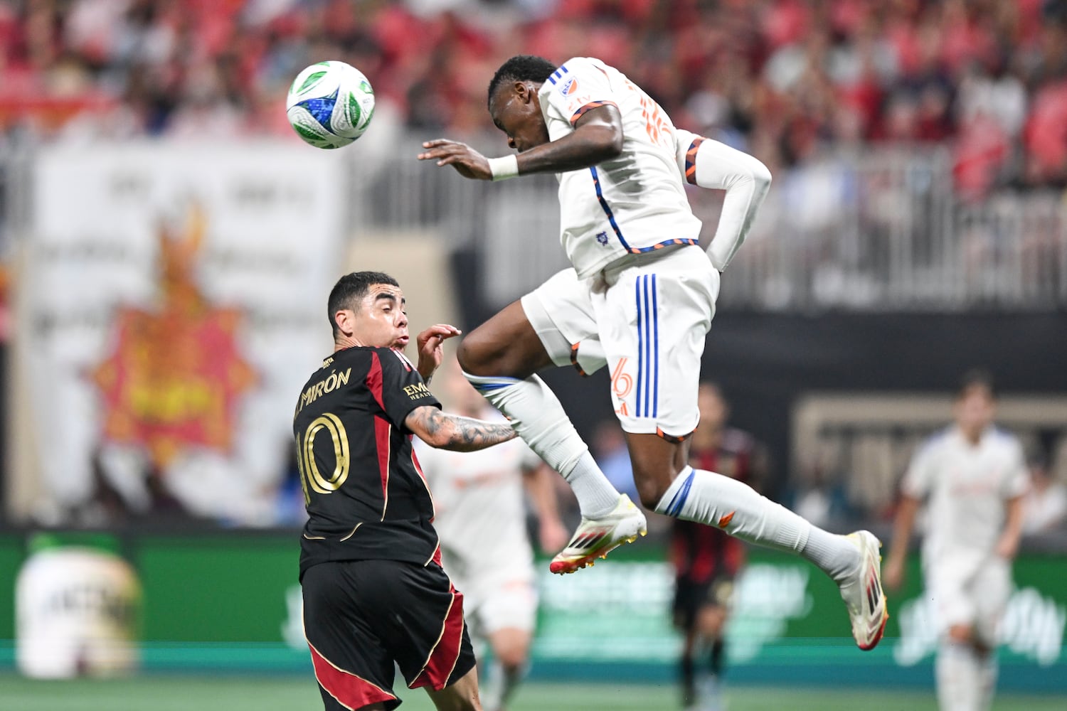 FC Cincinnati defender Teenage Hadebe (16) head butts a ball as Atlanta United midfielder Miguel Almirón (10) defends during the first half of a MLS soccer game Sunday, May 25, 2025 at the Mercedes-Benz Stadium. (Daniel Varnado/For the Atlanta Journal-Constitution)