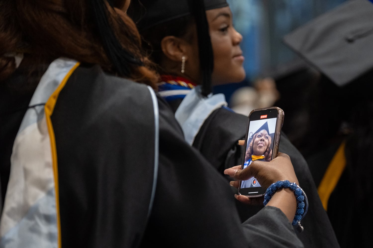 A student records as she processes at the start of the Spelman College graduation ceremony at the Georgia International Convention Center in College Park on Sunday, May 18, 2025.   Ben Gray for the Atlanta Journal-Constitution