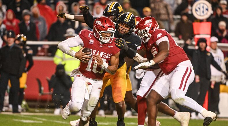 Arkansas quarterback Taylen Green (10) is sacked by Missouri defensive end Damon Wilson II, center, during the second half of an NCAA college football game Saturday, Nov. 29, 2025, in Fayetteville, Ark. (AP Photo/Michael Woods)