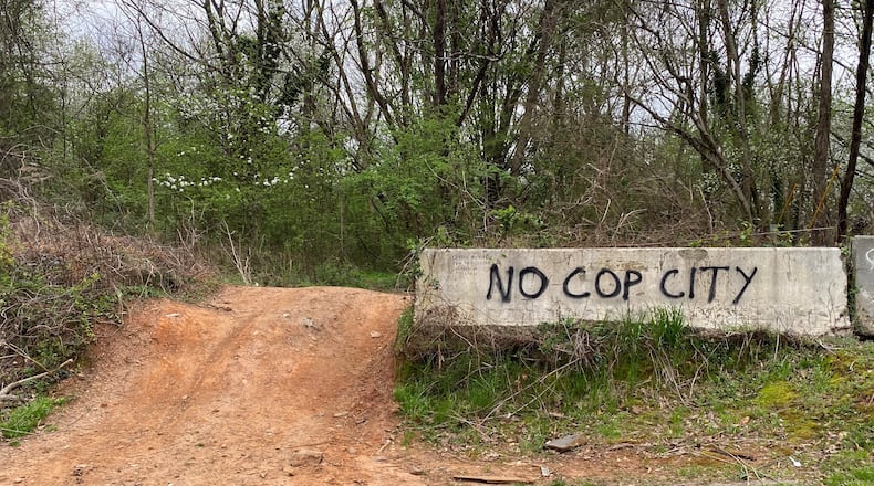Graffiti near a dirt part off Key Road in southern DeKalb County, just outside the property where the Atlanta Police Foundation plans to build a new public safety training center.