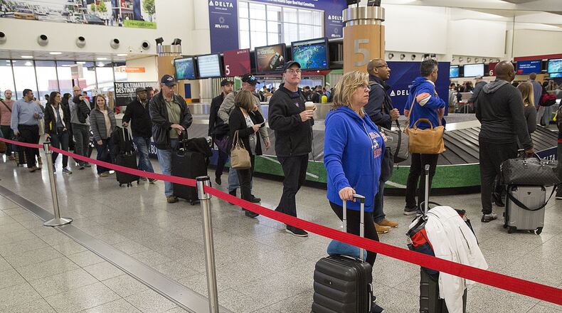 Travelers navigate multiple security lines at Hartsfield-Jackson International Airport the day after the 2019 Super Bowl. Officials expected over 100,00 travelers to pass through the airport that day. (Photo by Phil Skinner)