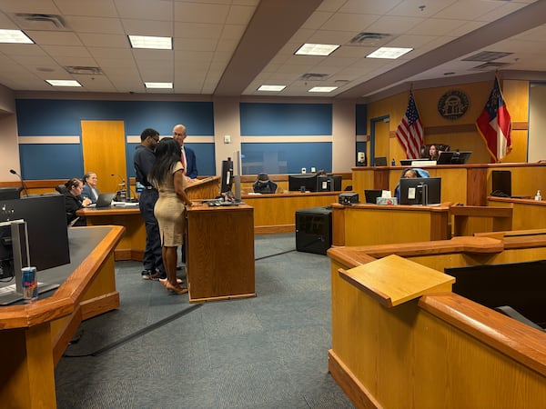 Deamonte Kendrick (center) stands with his attorneys during his plea hearing Wednesday, April 9, 2025. The musician, who performs under the stage name Yak Gotti, pleaded guilty to a single count of aggravated battery stemming from his time in jail during Fulton County's lengthy YSL trial. Kendrick was acquitted of all charges in that case. (Shaddi Abusaid/AJC)