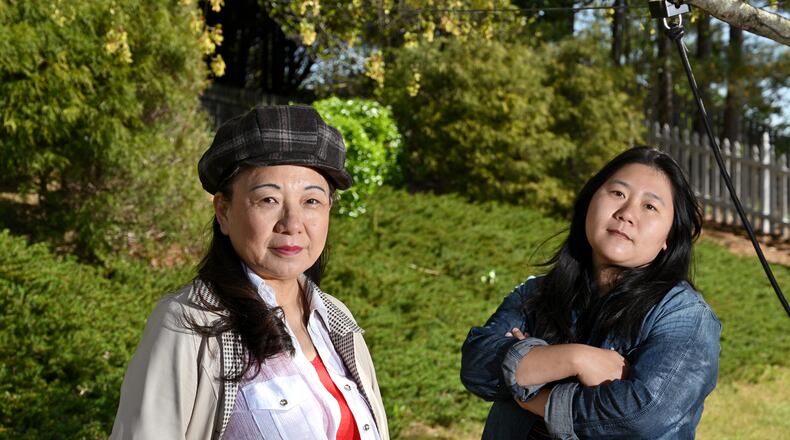 Jing Zheng (left) and Jing Su at Su's home in Suwanee on Thursday, April 1, 2021. They are friends and Chinese American immigrants who have joined recent vigils and rallies in the wake of the March 16 spa shootings, the first time for either of them. (Hyosub Shin / Hyosub.Shin@ajc.com)