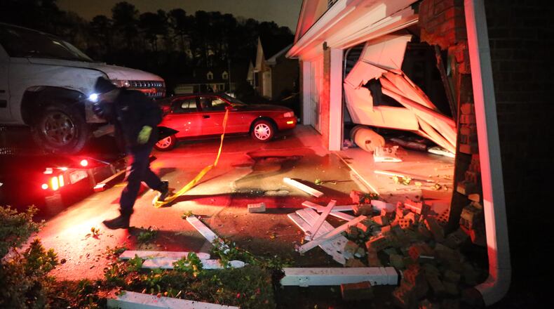 A motorist was injured when the pickup truck he was driving slammed into a house near Stone Mountain before daybreak Tuesday.