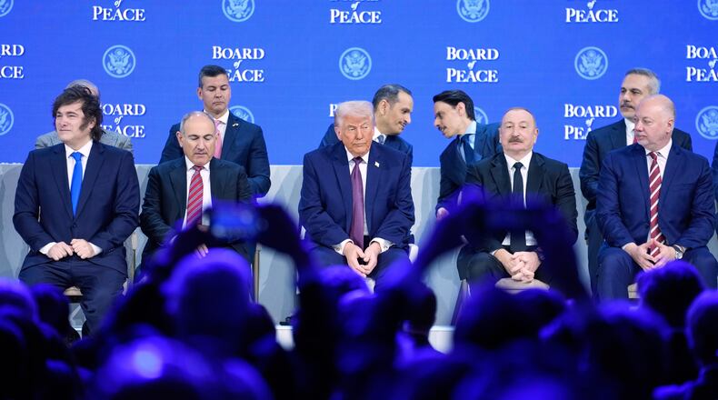 President Donald Trump sits on the podium during a session on the Board of Peace, his initiative, at the annual meeting of the World Economic Forum in Davos, Switzerland, Thursday, Jan. 22, 2026. (Markus Schreiber/AP)