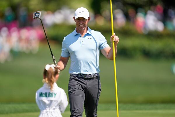 Rory McIlroy, of Northern Ireland, looks at his daughter, Poppy, on the first hole during the par-3 contest at the Masters golf tournament, Wednesday, April 9, 2025, in Augusta, Ga. (AP Photo/Ashley Landis)