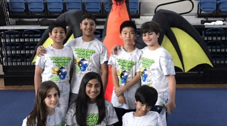 Woodward Academy North’s Odd-a-bot Division 2 Odyssey of the Mind team: (Kneeling, left to right) Alyssa Khahil, Mischa Patel, and Sachin Patel; and (standing, left to right) Rajveer Singh, Namit Miglani, Anderson Park, and Ryan Seeb.