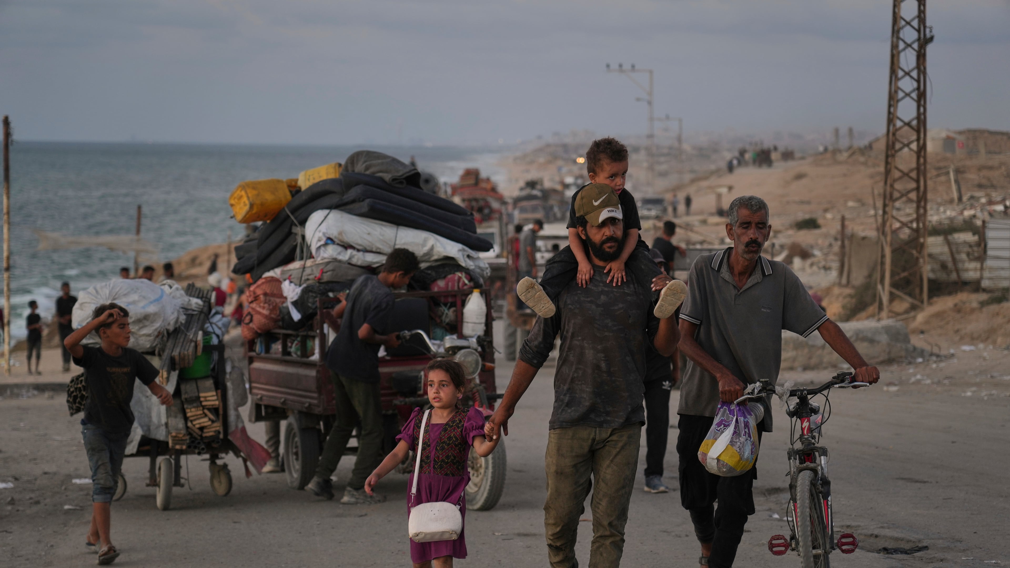 Displaced Palestinians flee northern Gaza along the coastal road toward the south, as Israel announced an expanded operation in Gaza City, Tuesday, Sept. 16, 2025. (AP Photo/Abdel Kareem Hana)