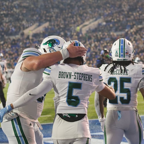 Tulane wide receiver Anthony Brown-Stephens (5) celebrates after his touchdown against Memphis with offensive lineman Jack Hollifield, left, and Jamauri McClure (25) during the first half of an NCAA college football game, Friday, Nov. 7, 2025, in Memphis, Tenn. (AP Photo/Nikki Boertman)
