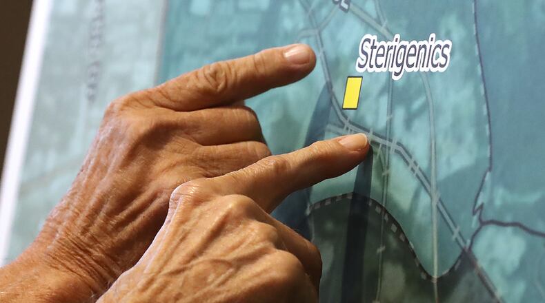 August 19, 2019 Marietta: Rick Gross (left) and his neighbor John Keller, who live near Sterigenics on Log Cabin Dr. SE, look over a NATA map of estimated total cancer risk around the Sterigenics site while Cobb officials and environmental regulators hold a town hall and community forum in the wake of reports that Cobb and Fulton have high levels of carcinogenic gas on Monday, August 19, 2019, in Marietta. A user and emitter of the gas, Sterigenics, which sterilizes medical equipment, operates in the area. Curtis Compton/ccompton@ajc.com