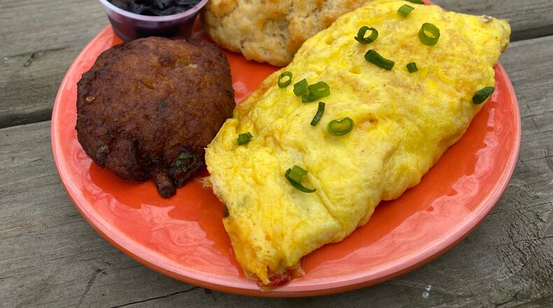 The pimento cheese omelet, which comes with a biscuit and choice of side, is a popular menu item at Buttermilk Kitchen in Buckhead. Ligaya Figueras/ligaya.figueras@ajc.com