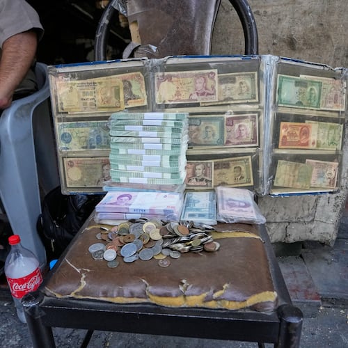 Current and pre-revolution Iranian banknotes are displayed by a street money exchanger at Ferdowsi square, Tehran's go-to venue for foreign currency exchange, in downtown Tehran, Iran, Monday, Aug. 24, 2026. AP Photo/Vahid Salemi)