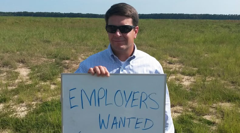 Trip Tollison is one of the state and local salesmen trying to land a big one for the Pooler site. (We talked him in to holding the sign.)
