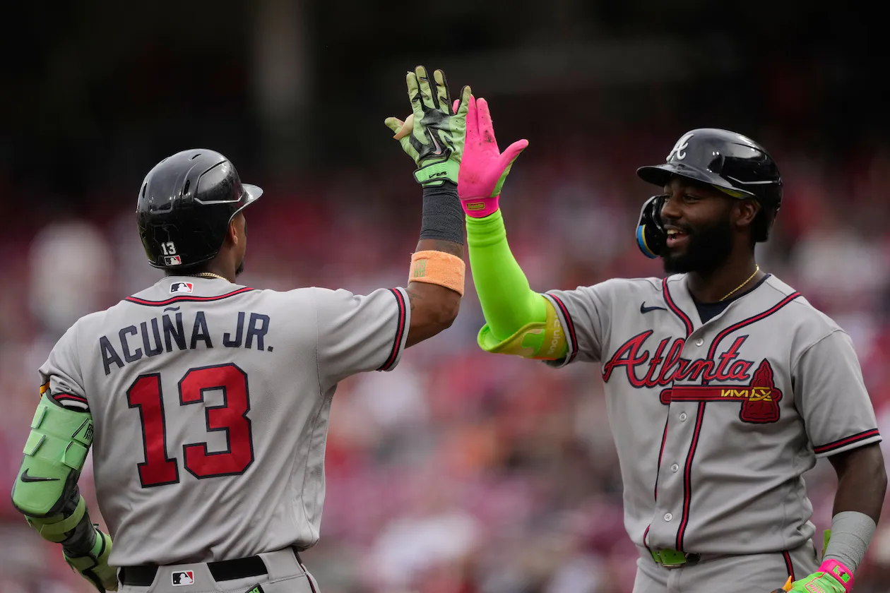 Atlanta Braves' Ronald Acuña Jr. left, celebrates after hitting a solo home run with Michael Harris II, right, during the first inning of a baseball game against the Cincinnati Reds in Cincinnati, Friday, May 29, 2026. (AP Photo/Carolyn Kaster)