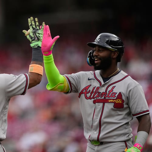 Atlanta Braves' Ronald Acuña Jr. left, celebrates after hitting a solo home run with Michael Harris II, right, during the first inning of a baseball game against the Cincinnati Reds in Cincinnati, Friday, May 29, 2026. (AP Photo/Carolyn Kaster)