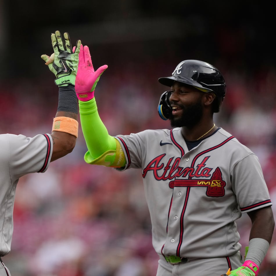 Atlanta Braves' Ronald Acuña Jr. left, celebrates after hitting a solo home run with Michael Harris II, right, during the first inning of a baseball game against the Cincinnati Reds in Cincinnati, Friday, May 29, 2026. (AP Photo/Carolyn Kaster)