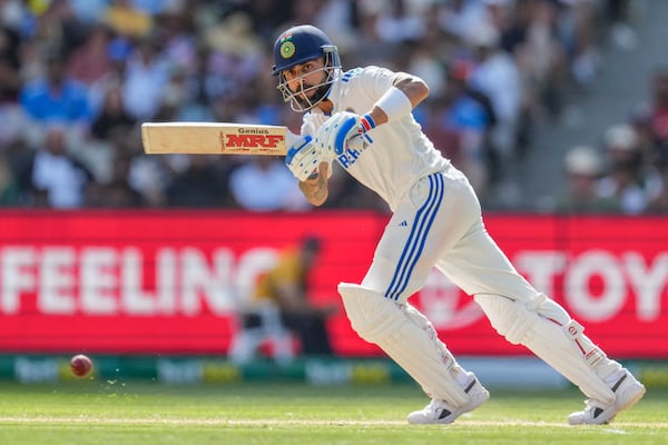 FILE - India's Virat Kohli watches the ball after playing a shot during play on the second day of the fourth cricket test between Australia and India at the Melbourne Cricket Ground, Melbourne, Australia, on Dec. 27, 2024. (AP Photo/Asanka Brendon Ratnayake, File)