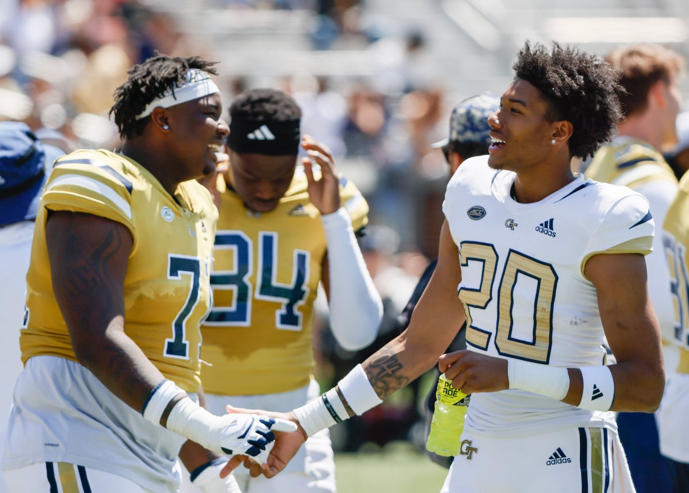 Offensive lineman Peyton Joseph (left) talks with defense back Christian Pritchett  during Georgia Tech football team's annual White and Gold game in Atlanta on Saturday, April 12, 2025.  Players split into two teams — Team Swarm and Team Wreck ‘Em — with some players being asked to play on both squads.  (Bob Andres for the Atlanta Journal Constitution)