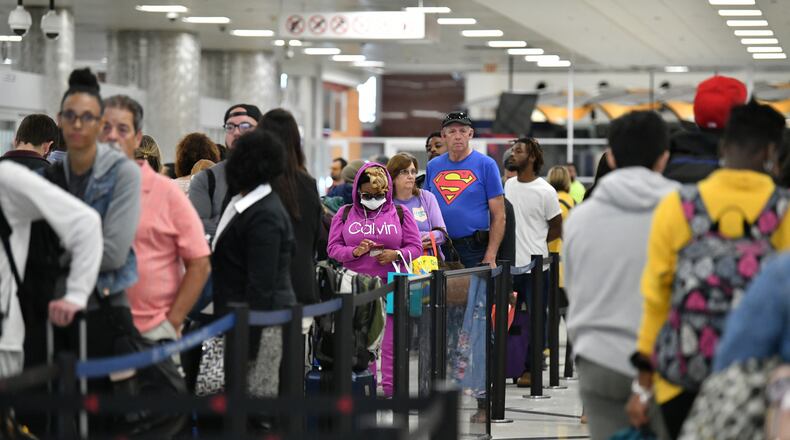 Although the terminal was quiet, the security checkpoint waiting time showed 30 to 45 minutes since both north and south checkpoints were closed at Hartsfield-Jackson International Airport on Saturday, March 21, 2020. Health guidelines say that staying at least 6 feet away from other people lessens your chances of catching COVID-19, the disease caused by the coronavirus. (Hyosub Shin / Hyosub.Shin@ajc.com)