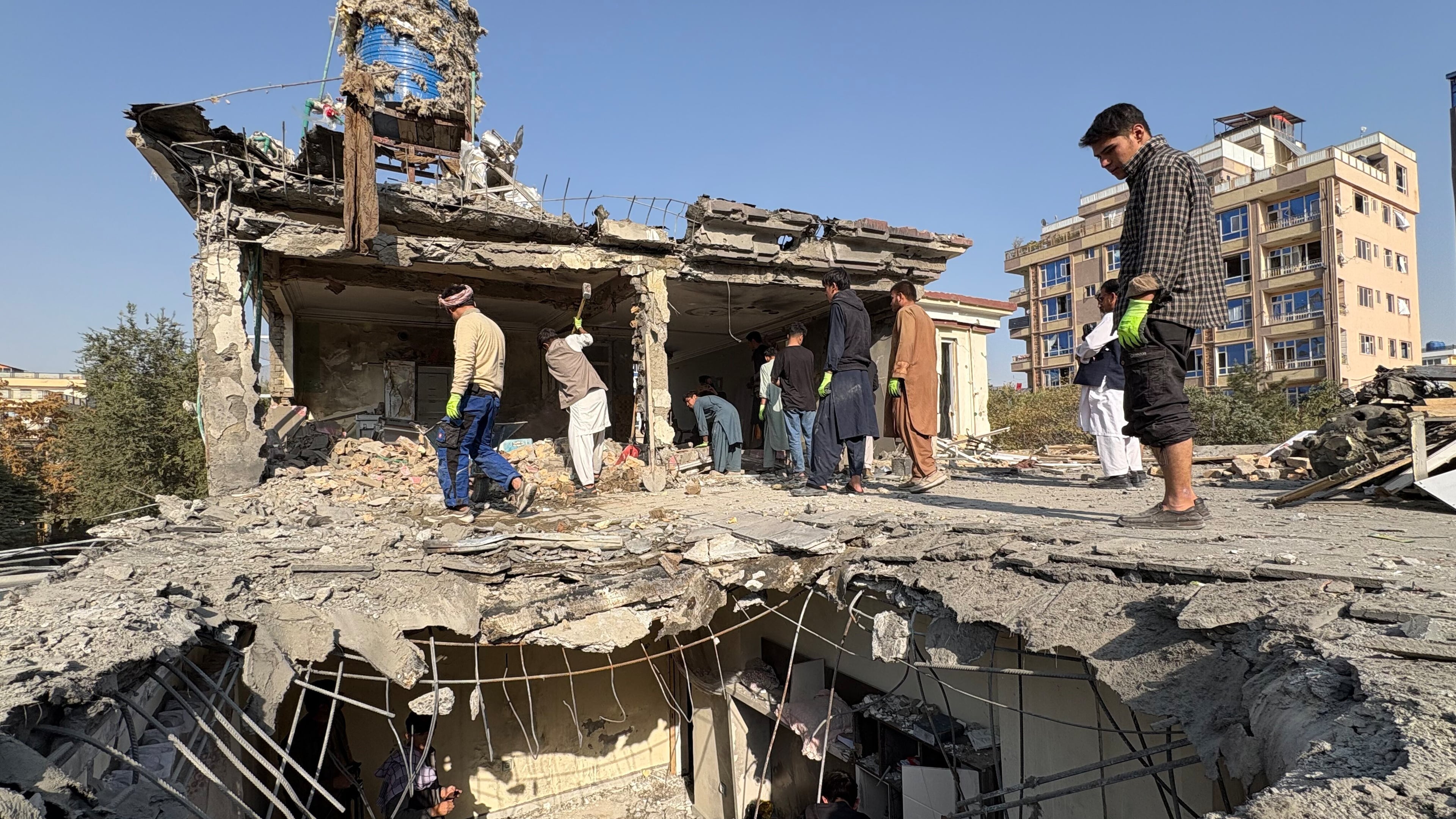Residents remove debris from a house damaged by Wednesday's two drone strikes, in Kabul, Afghanistan, Thursday, Oct. 16, 2025. (AP Photo/Siddiqullah Alizai)