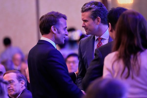 French President Emmanuel Macron, left, and U.S. Defense Secretary Pete Hegseth talk during the 22nd Shangri-La Dialogue summit in Singapore, Friday, May 30, 2025. (AP Photo/Anupam Nath)