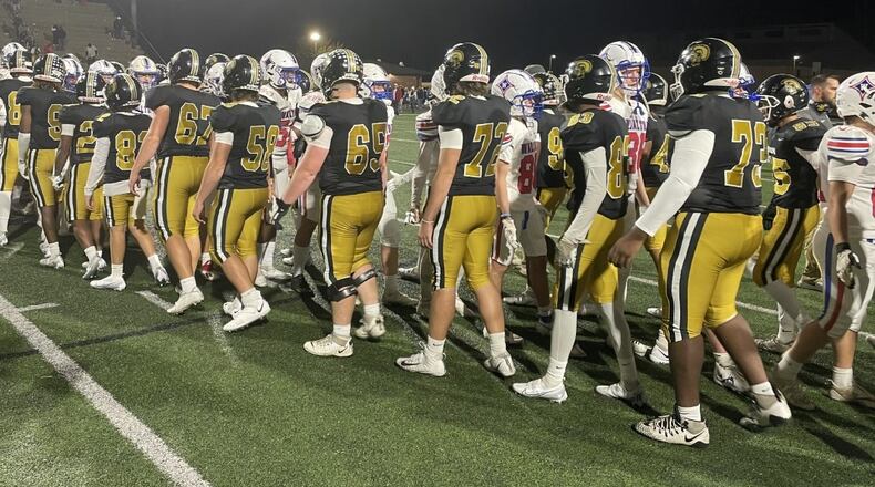 Players exchange handshakes after Carrollton's 52-27 victory over Walton in the Class 7A quarterfinals on Nov. 25, 2022, at Carrollton's Grisham Stadium.