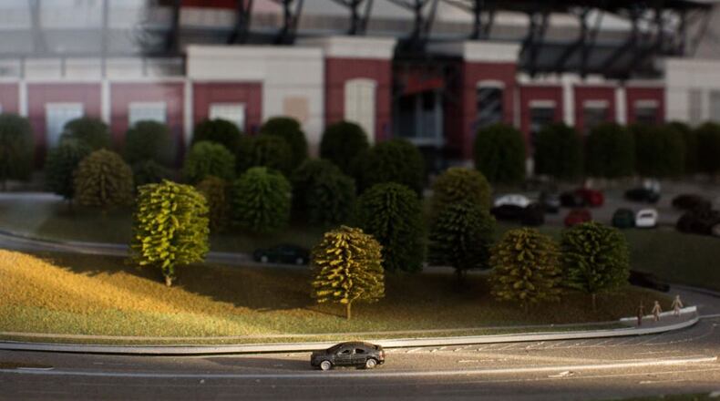 A model car sits alone on a road surrounding a scale model of the new Braves stadium at the SunTrust Park Preview Center. BRANDEN CAMP/SPECIAL